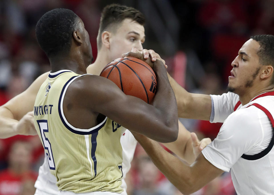 North Carolina State's Jericole Hellems, right, pressures Georgia Tech's Moses Wright (5) during the first half of an NCAA college basketball game at PNC Arena in Raleigh, N.C., Tuesday, Nov. 5, 2019. (Ethan Hyman/The News & Observer via AP)