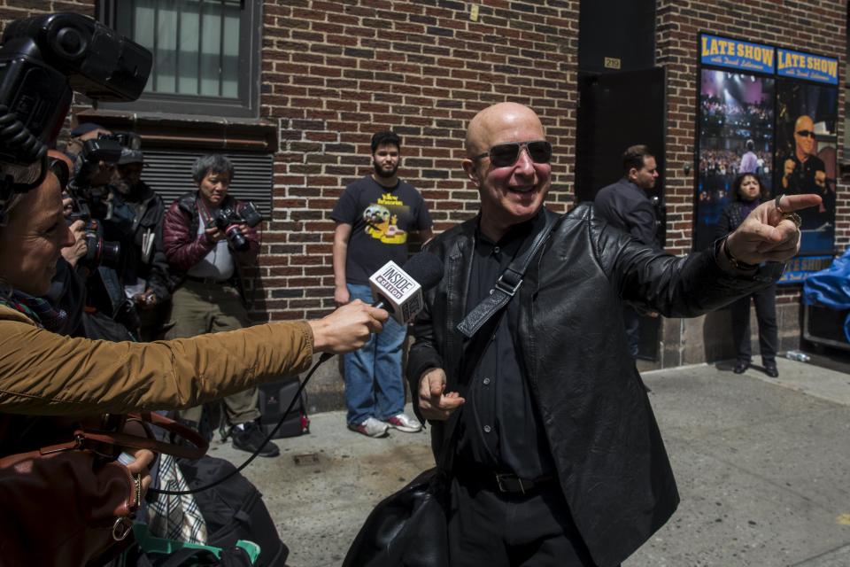 Musician Paul Shaffer gestures to fans as he arrives at Ed Sullivan Theater in Manhattan as David Letterman prepares for the taping of tonight's final edition of "The Late Show" in New York