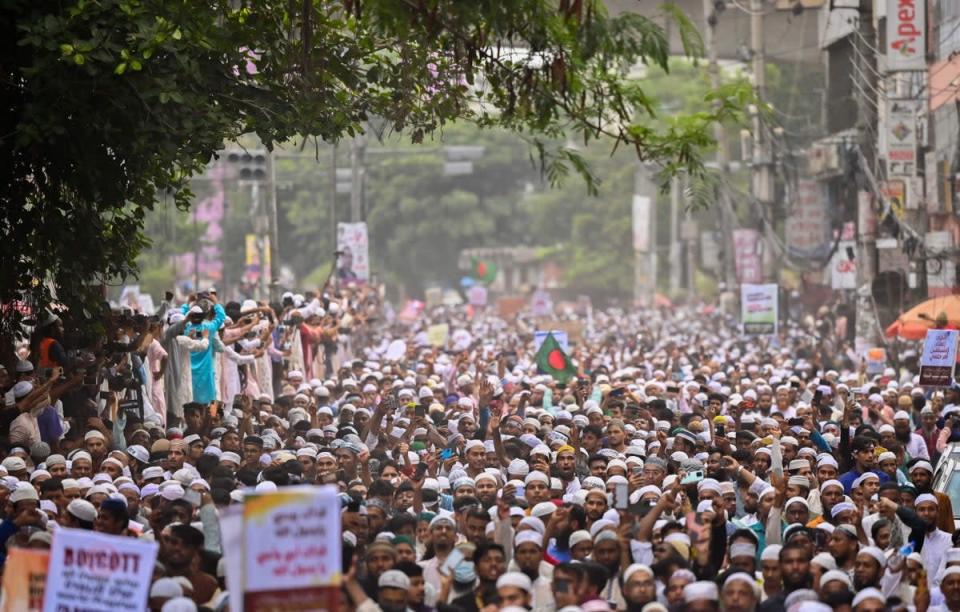 Bangladesh’s Islamist parties’ activists and supporters hold placards and shout anti-India slogans during a demonstration in Dhaka on 10 June to protest former BJP spokeswoman Nupur Sharma over her incendiary remarks about prophet Muhammad (AFP via Getty Images/Munir uz Zaman)