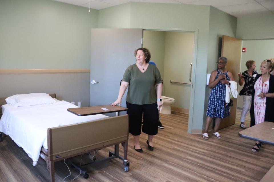 At left, Holly Klein, executive director of Grace House Akron, shows supporters a bedroom at the hospice. The facility hopes to house its first residents by late July.