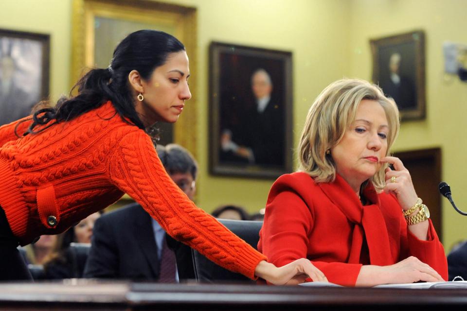 U.S. Secretary of State Hillary Clinton (R) receives a note from her aide Huma Abedin (L) as she testifies about the State Department's FY2012 budget during a hearing of the State, Foreign Operations and Related Programs Subcommittee of the House Appropriations Committee in the Rayburn House Office Building on March 10, 2011 in Washington, DC. Secretary Clinton has recently warned that proposed budget cuts would have a negative effect on U.S. national security policy.