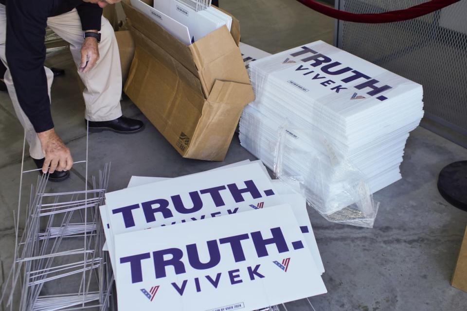 Lawn signs are unpacked as presidential candidate Vivek Ramaswamy speaks at a campaign stop  in Ohio.