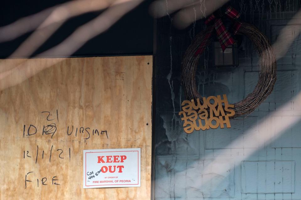 The boarded up front door of a house at 1021 E. Virginia Ave. where one person was killed in a house fire on Dec. 1, 2021.