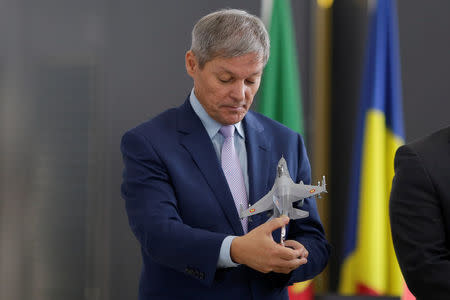 Romania's Prime Minister Dacian Ciolos looks at a scale model of a F-16 Fighting Falcon airplane at 86th Air Base of Romanian Air Force during the official presentation ceremony of 6 F-16 planes bought by the Romanian government, in Fetesti, Calarasi county, Romania October 7, 2016. Inquam Photos/Octav Ganea/via REUTERS