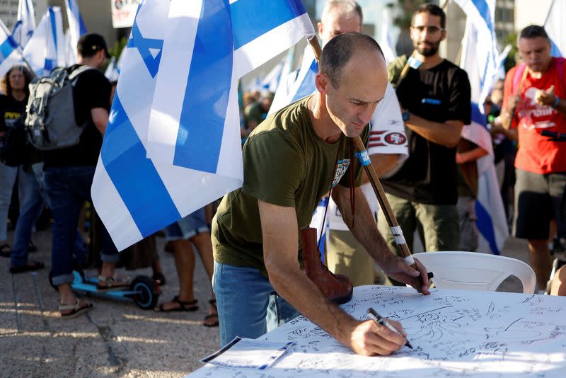 FILE PHOTO: Israeli military reservists sign pledge to suspend voluntary military service if the government passes judicial overhaul legislation, near the defence ministry in Tel Aviv