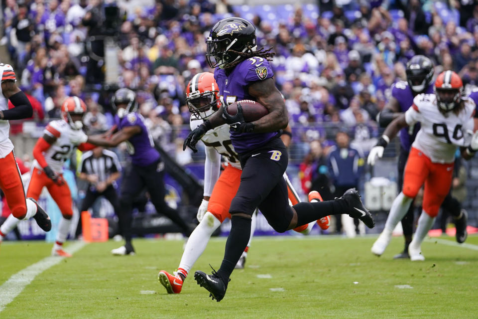 Baltimore Ravens running back Gus Edwards (35) runs past Cleveland Browns linebacker Jacob Phillips (50) to score a touchdown in the first half of an NFL football game Sunday, Oct. 23, 2022, in Baltimore. (AP Photo/Julio Cortez)