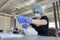 This undated image provided by LifeBridge Health shows masks being made in Baltimore. LifeBridge converted a building completed a year ago in the Baltimore suburbs into a factory to produce masks, with some of the fabric coming from Under Armor, which is based in the state. (Scott Wendler/LifeBridge Health via AP)