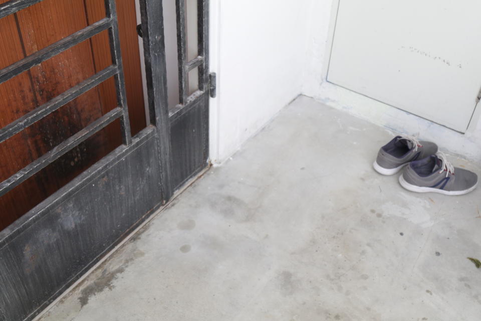 Burn marks can be seen on the door of a HDB unit targeted by a loanshark harasser. Photo: Hannah Teoh/Yahoo News Singapore