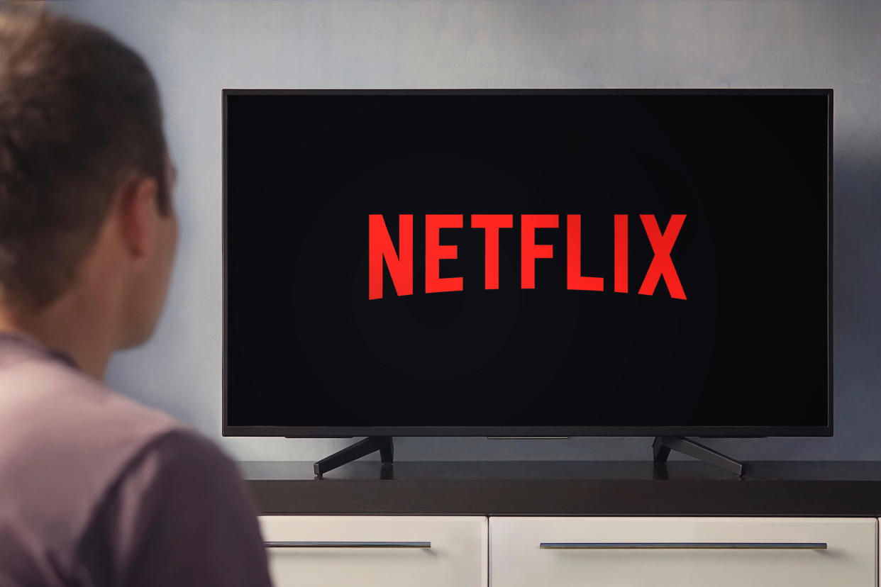  Man watching Netflix on TV. 