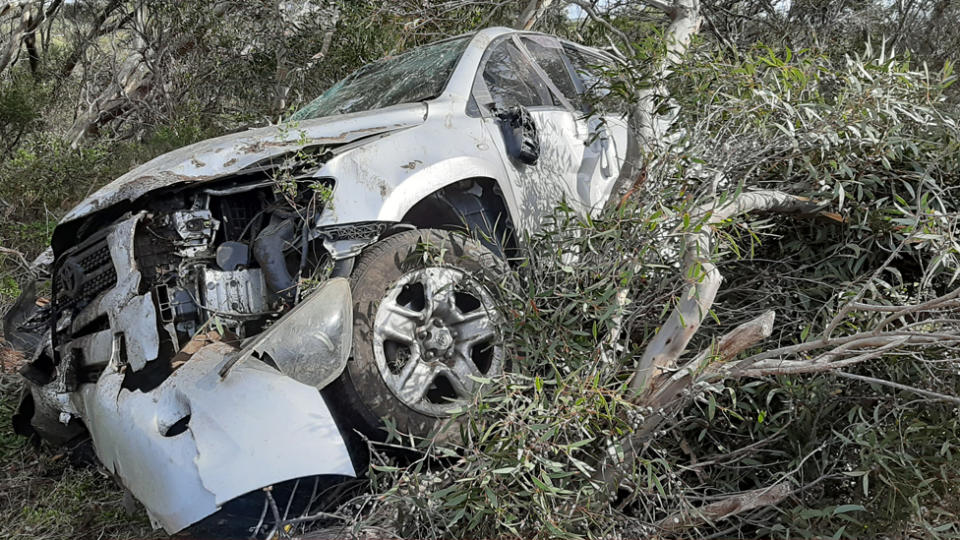 A car wreck after the vehicle flipped over and landed in trees.