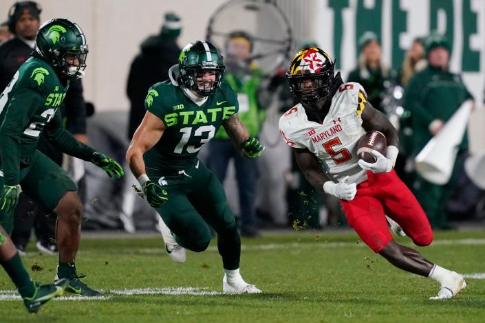 Maryland wide receiver Rakim Jarrett (5) is chased by Michigan State linebacker Ben VanSumeren (13) during the second half of an NCAA college football game, Saturday, Nov. 13, 2021, in East Lansing, Mich. (AP Photo/Carlos Osorio)
