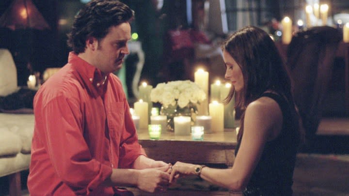 Chandler on his knee proposing to Monica in a scene from Friends.