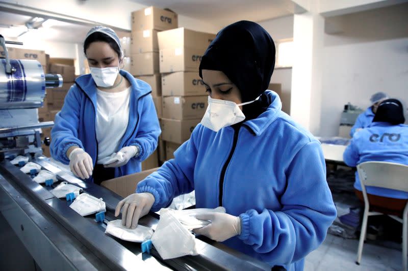Workers produce face masks as the demand for their production rapidly increased and struggles to meet orders, at a Turkish manufacturer's facility in Istanbul