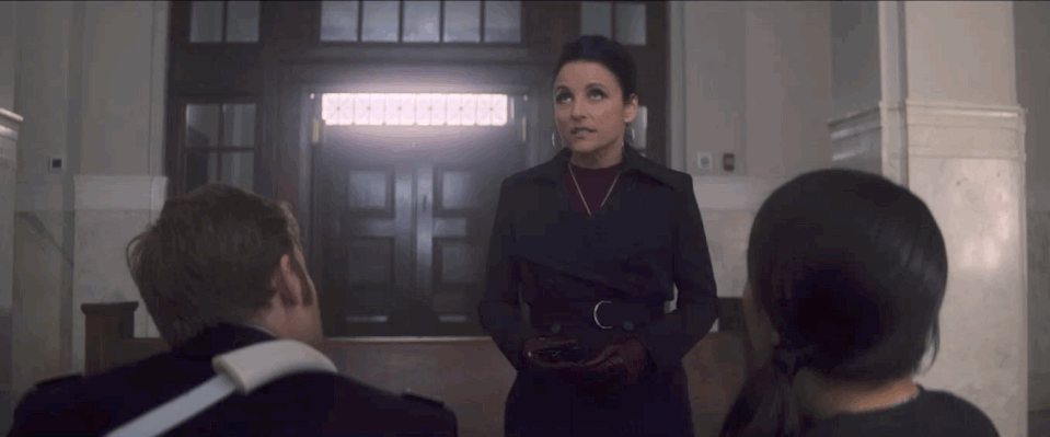 A gif of Julia Louis-Dreyfus on The Falcon and the Winter Soldier as Contessa Valentina Allegra de la Fontaine in a purple coat talking to John Walker and his wife
