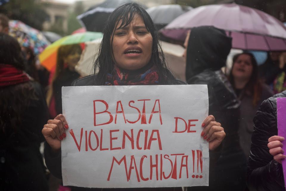 A woman in Buenos Aires&nbsp;protests with a sign that says "Stop Sexist&nbsp;Violence."