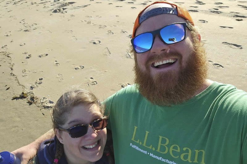 This photo provided by Patrick Acord shows him, right, with his wife, Jamie Acord, on Popham Beach, where Jamie Acord sunk to her hips in quicksand, Saturday, June 1, 2024, in Phippsburg, Maine. (Patrick Acord via AP)