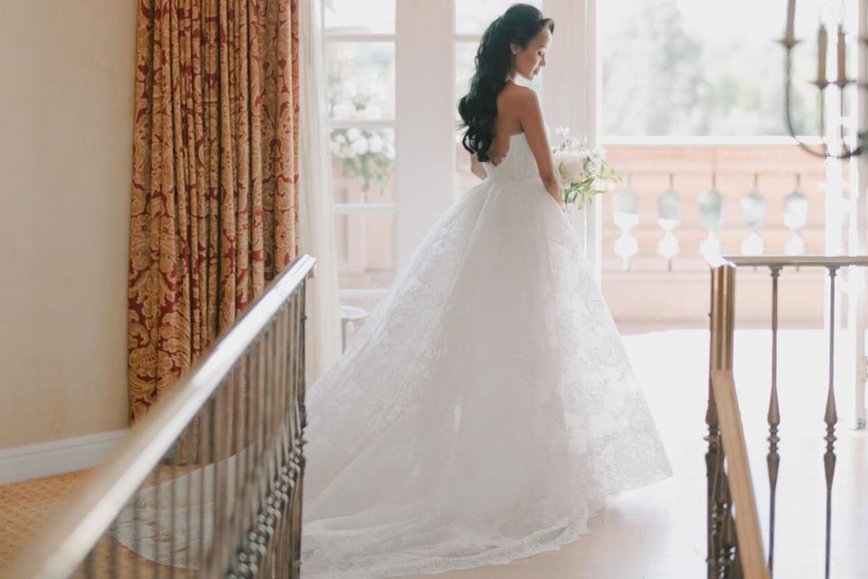 bride in wedding dress near balcony