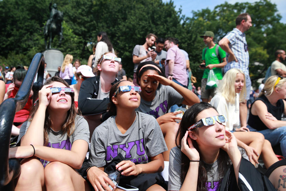 <p>Members of the NYU womenâs volleyball team take a break from school to see the total solar eclipse in Union Square, New York City, on Aug. 21, 2017. (Gordon Donovan/Yahoo News) </p>