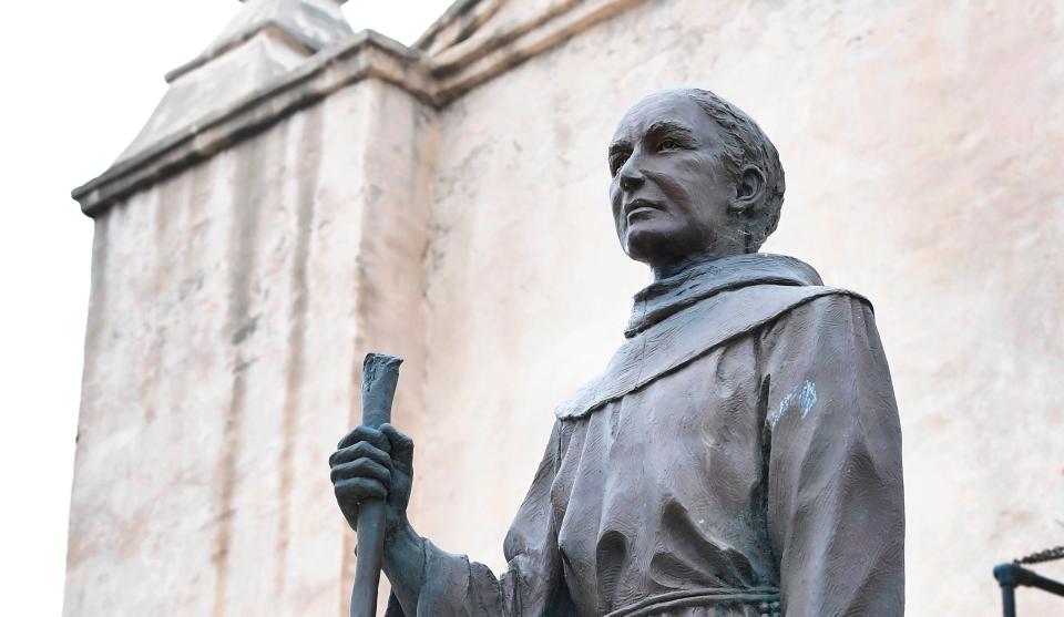 A statue of Father Junipero Serra is seen in front of the San Gabriel Mission in San Gabriel, California on June 21, 2020. - Serra, recognized as one of the most important Spanish missionaries and one of the founding priests of the San Gabriel Mission in 1771, the first of nine missions across California, was canonized by Pope Francis in 2015 but remains a controversial figure especially by California's Native Americans who accuse him of destroying their culture and tribes. (Photo by Frederic J. BROWN / AFP)