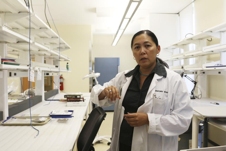 Forensic anthropologist and laboratory manager Denise To talks to The Associated Press at the U.S. Defense POW/MIA Accounting Agency Laboratory at Joint Base Pearl Harbor-Hickam, Hawaii on Tuesday, July 31, 2018. Human remains handed over to the U.S. government from North Korea are expected to arrive at the lab Wednesday where scientists will begin the process of trying to match the bones to American soldiers who didn't return from the Korean War. (AP Photo/Caleb Jones)