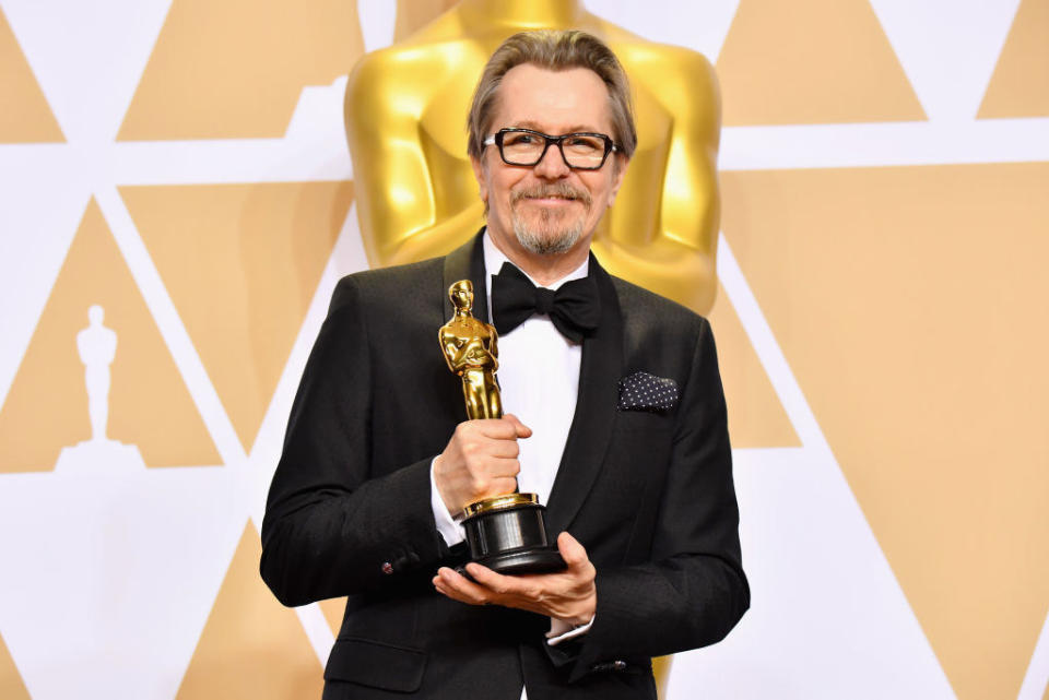 Gary in a bow tie holding an Oscar