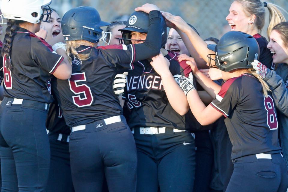 Cat Neville gets mobbed at home plate by her East Greenwich teammates after her game-winning grand slam gave the Avengers a 7-3 win over Cumberland, a good start to the D-I season for last spring's D-II champs.