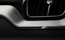 <p>Just in case you fail to notice the Swedish flag tag on the XC60's seat, Volvo molds one into the chrome trim running across the dashboard, just beneath the passenger-side A/C vent.</p>