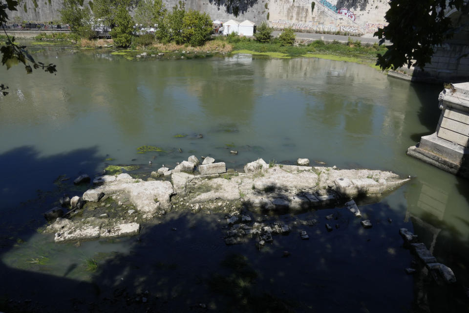 The ruins of the ancient Roman Neronian bridge, emerge from the river bed of the Tiber river, in Rome, Monday, Aug. 22, 2022. Italy’s worst drought in 70 years has exposed the piers of an ancient bridge over the Tiber River once used by Roman emperors but which fell into disrepair by the 3rd Century. (AP Photo/Gregorio Borgia)