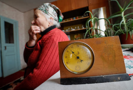 Retired school principal Nadiya Yurchenko, 79, is seen in her house as the thermometer on her living room table shows 5 degrees Celsius in the village of Skryhalivka, Kiev region, Ukraine February 11, 2019. REUTERS/Gleb Garanich