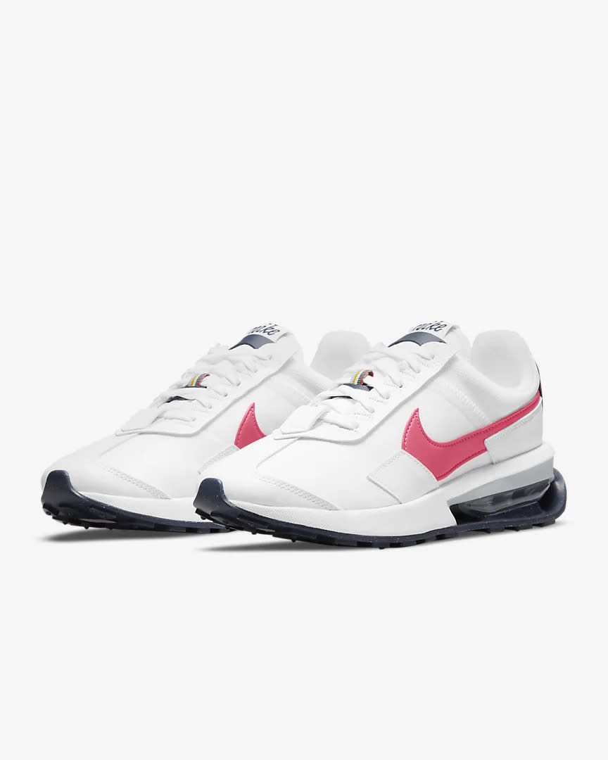 White shoes with pink Nike Swoosh.