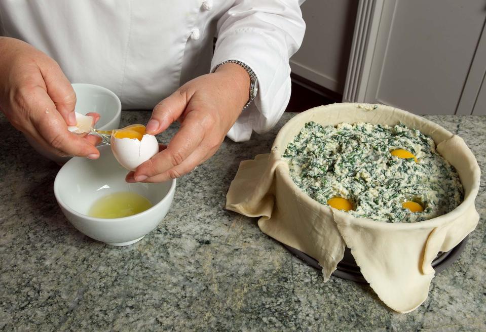 With the pointy tip of a spoon or spatula, make four wells in the batter. Fill each well with an egg, making sure to drain off excess liquid from the eggs.