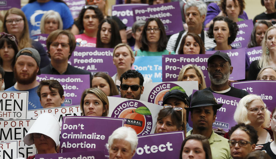 FILE - In this May 16, 2019 file photo, abortion rights supporters stand during a news conference by Presidential candidate Sen. Kirsten Gillibrand, D-N.Y., at the Georgia State Capitol in Atlanta to discuss abortion bans in Georgia and across the country. A federal appeals court plans to hear arguments Friday, Sept. 24, 2021 on whether it should overturn a lower court’s ruling that permanently blocks a restrictive abortion law passed in 2019 by Georgia lawmakers. (Bob Andres/Atlanta Journal-Constitution via AP)