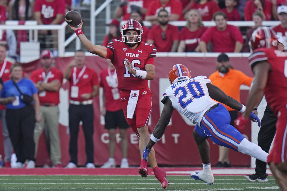 Utah quarterback Bryson Barnes (16) throws a pass as Florida linebacker Teradja Mitchell (20) defends during the first half of an NCAA college football game Thursday, Aug. 31, 2023, in Salt Lake City. (AP Photo/Rick Bowmer)