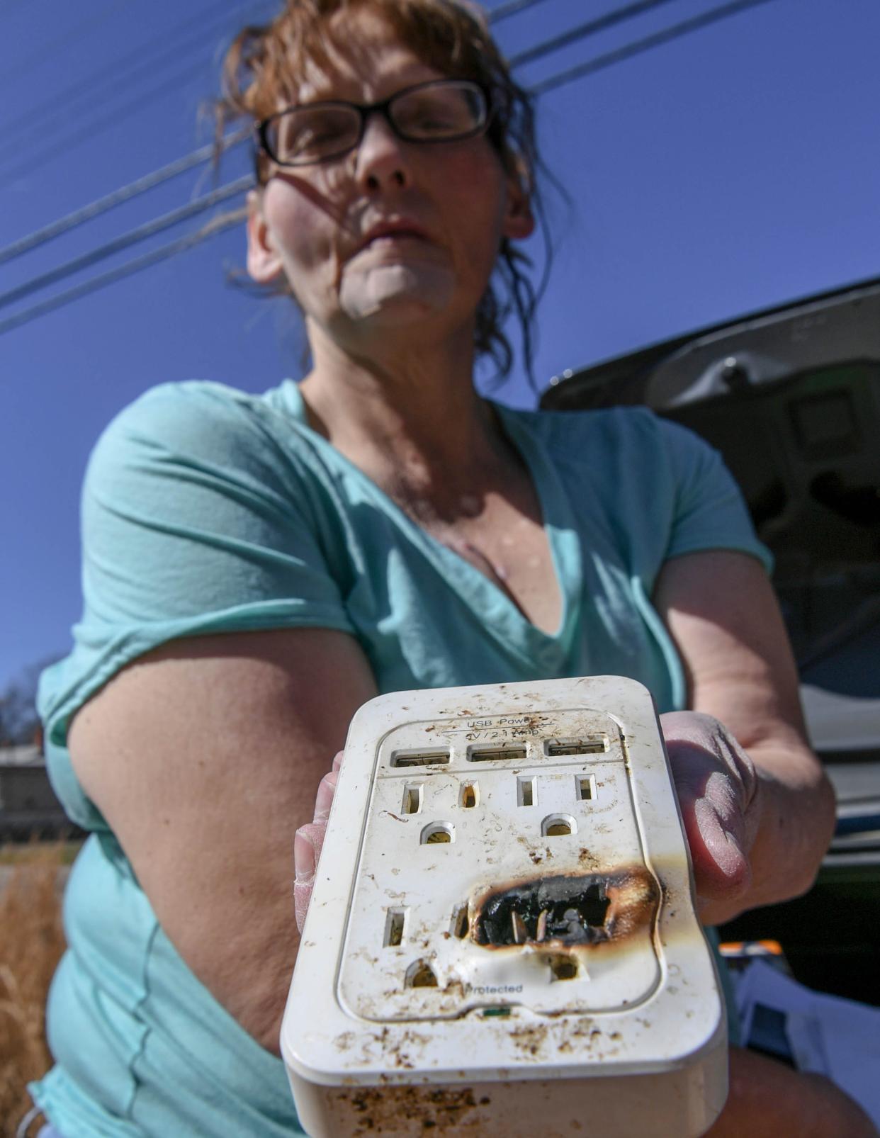 A South Carolina woman shows a power splitter that sparked and caught fire in a home she rents.