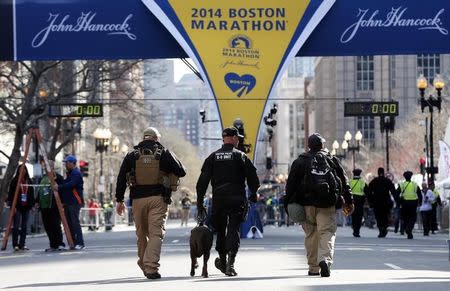 Apr 21, 2014; Boston, MA, USA; Boston police officers part of the K-9 unit patrol Boylston Street near the finish line before the start of the 2014 Boston Marathon. Mandatory Credit: Greg M. Cooper-USA TODAY Sports