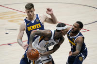 Utah Jazz guard Jordan Clarkson, front left, is trapped in the corner with the ball by Denver Nuggets guard Monte Morris, front right, and center Isaiah Hartenstein in the first half of an NBA basketball game Sunday, Jan. 17, 2021, in Denver. (AP Photo/David Zalubowski)