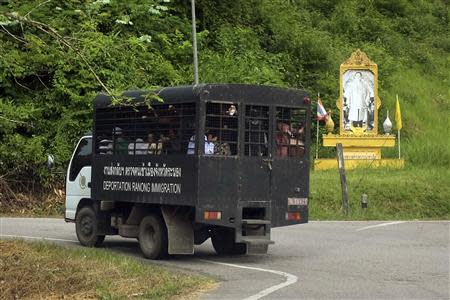 A Thailand Immigration Police van carries a group of Rohingya Muslims to a port outside Ranong city October 30, 2013. REUTERS/Andrew RC Marshall