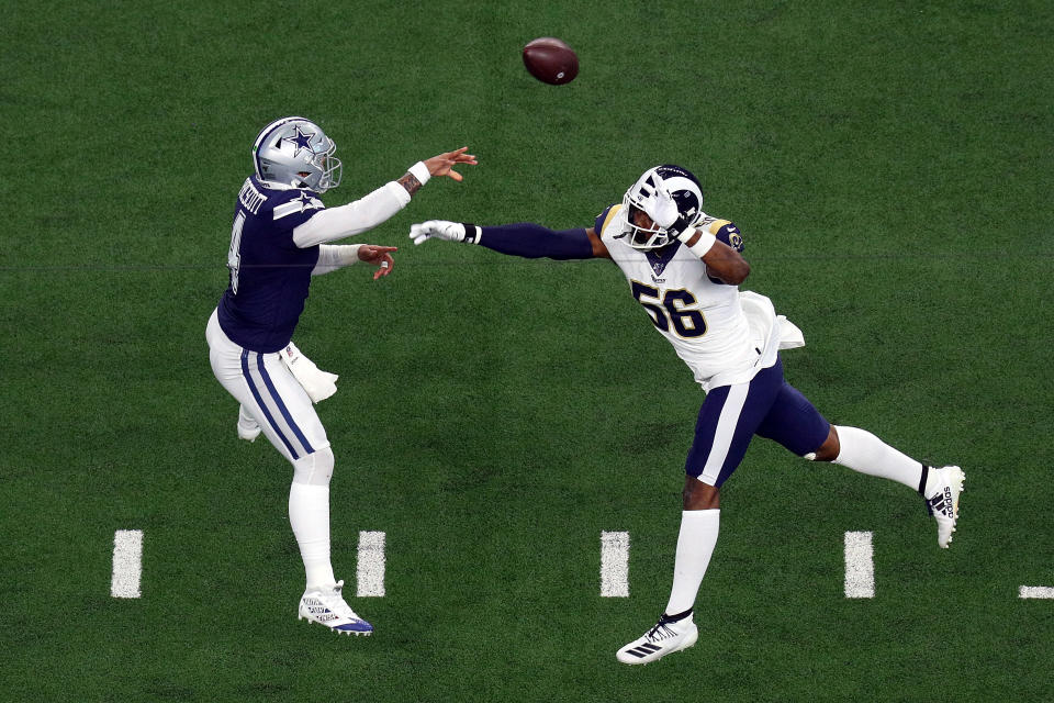 ARLINGTON, TEXAS - DECEMBER 15: Dak Prescott #4 of the Dallas Cowboys passes under pressure from Dante Fowler #56 of the Los Angeles Rams in the first quarter at AT&T Stadium on December 15, 2019 in Arlington, Texas. (Photo by Richard Rodriguez/Getty Images)