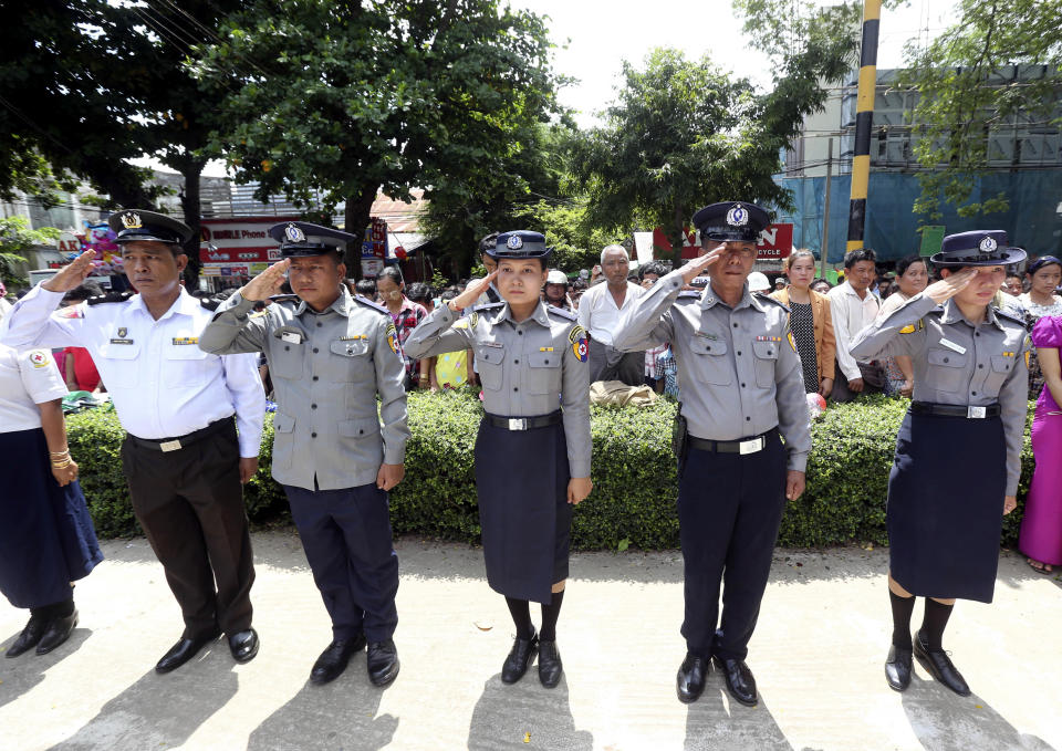 Myanmar police salute to the tomb of national hero Gen. Aung San during a ceremony to mark the 72nd anniversary of the 1947 assassination of independence heroes including Gen. Aung San, the late father of Myanmar leader Aung San Suu Kyi, Friday, July 19, 2019, in Naypyitaw, Myanmar. The country's Independence hero Gen. Aung San and his cabinet were gunned down in 1947.(AP Photo/Aung Shine Oo)