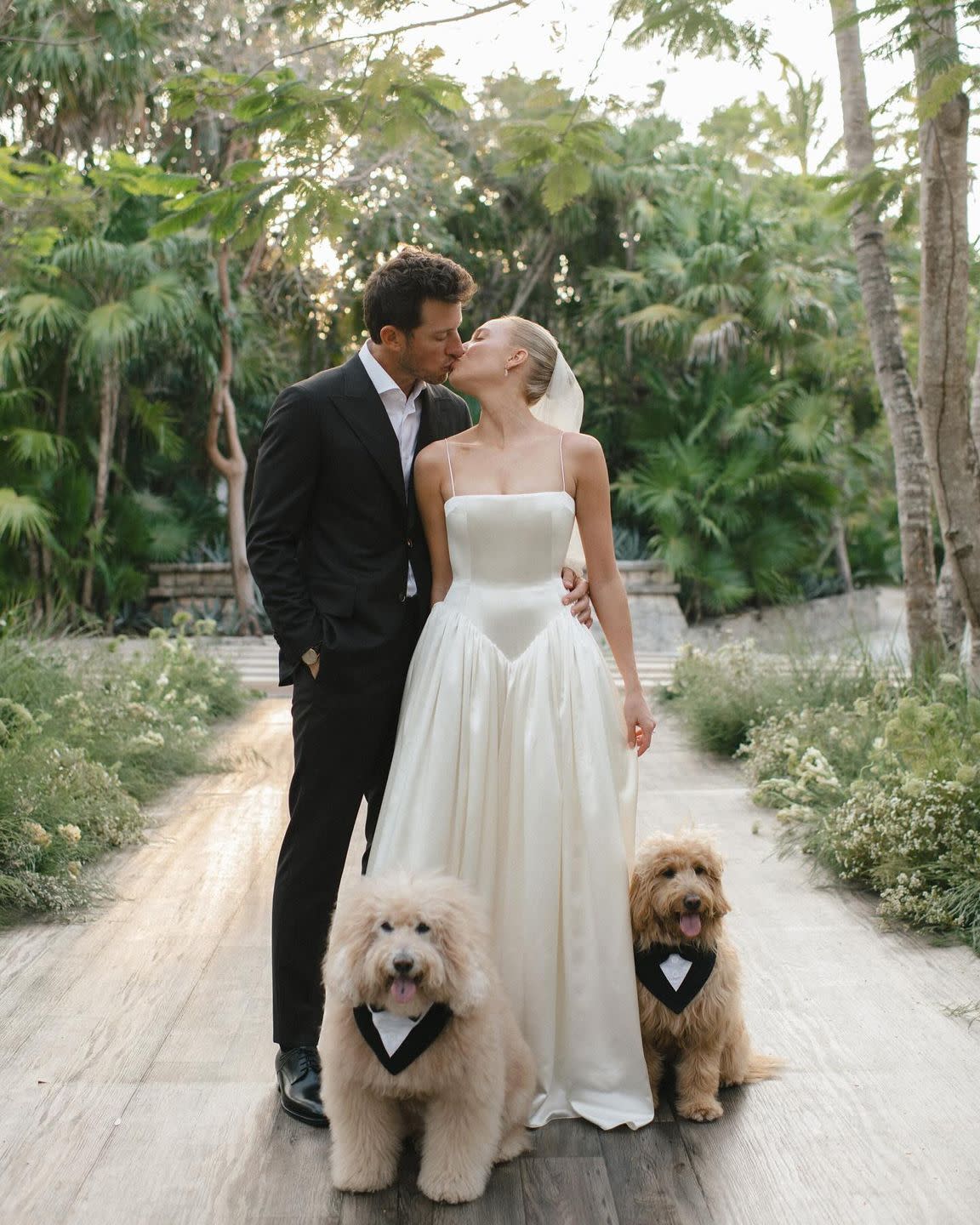 a man and woman holding dogs