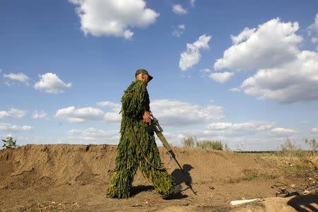 A Ukrainian sniper takes position outside of a military camp in Luhansk region August 21, 2014. REUTERS/Valentyn Ogirenko