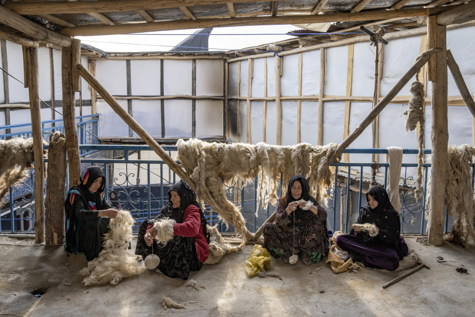 Afghan women weave wools for making carpets at a traditional carpet factory in Kabul, Afghanistan, Monday, March 6, 2023. After the Taliban came to power in Afghanistan, women have been deprived of many of their basic rights. (AP Photo/Ebrahim Noroozi)