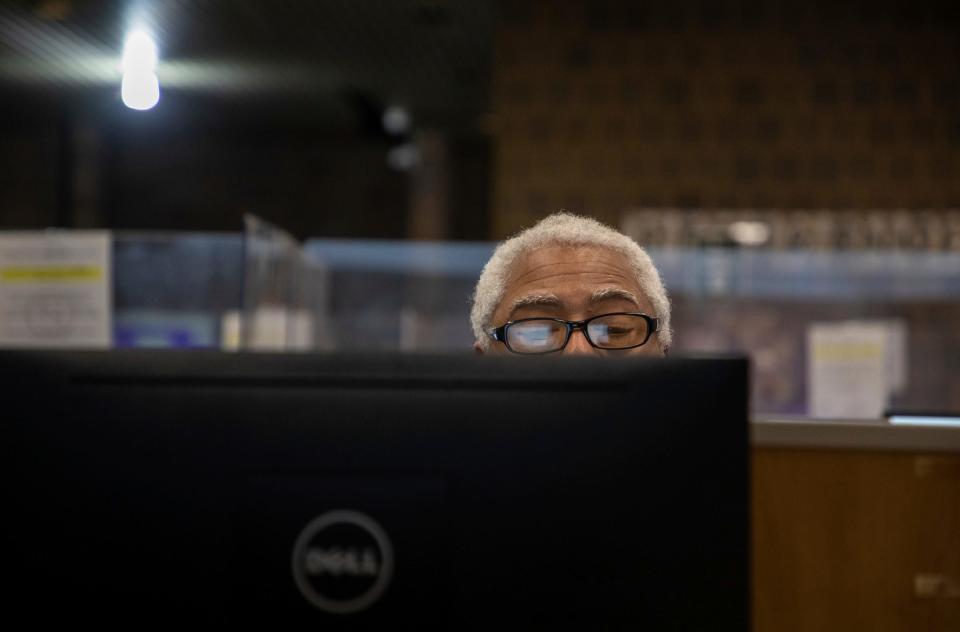 Lionel Booker looks at a monitor as he uses an online database through the Detroit Public Library to research his ancestry at the Redford Branch in Detroit on Nov. 21, 2023. The Finding Your Roots class is offered every first and third Tuesday of the month.