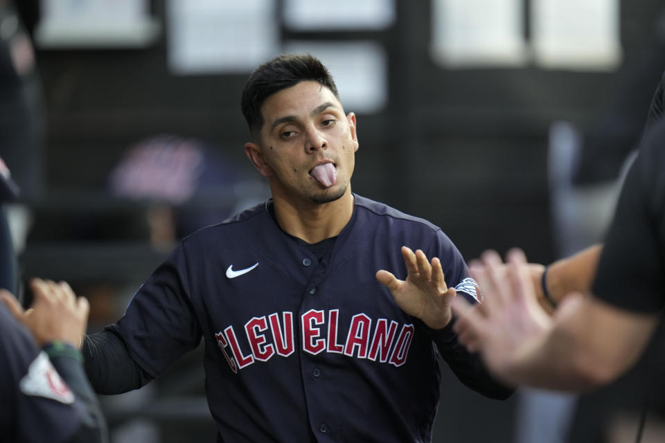 Cleveland Guardians' Andres Gimenez is greeted in the dugout after scoring agains the Chicago White Sox during the third inning of a baseball game Thursday, July 27, 2023, in Chicago. (AP Photo/Erin Hooley)
