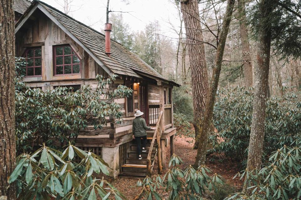 A guest climbing the stairs to a cabin at Half-Mile Farm