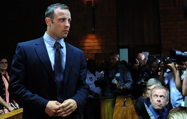 South African Paralympic icon and murder suspect Oscar Pistorius appears at court in Pretoria on February 22, 2013. Pistorius spent his first day out on bail with his family Saturday