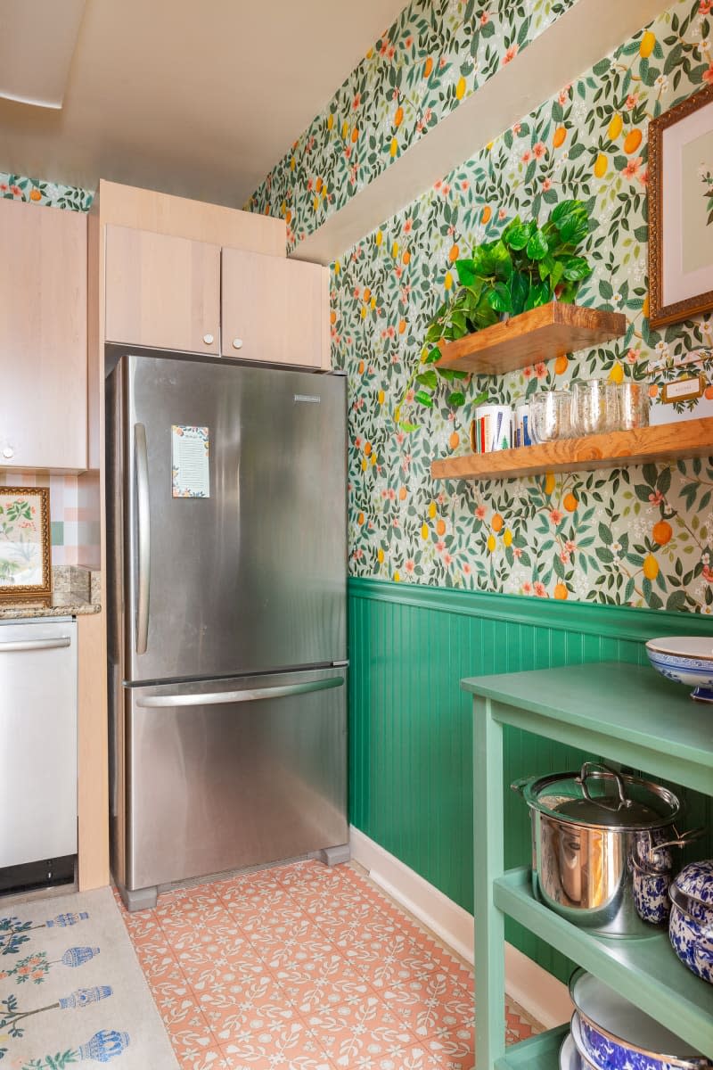 A kitchen with stainless steel appliances and light wood cabinets.