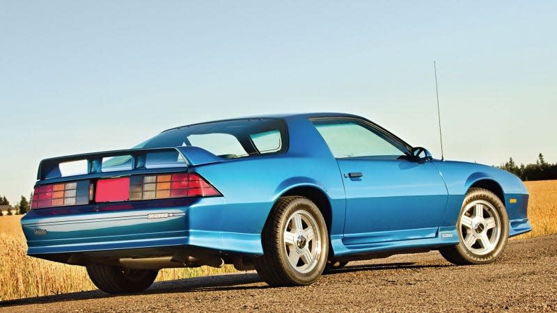 A photo of a blue Chevrolet Camaro from the 1990s. 