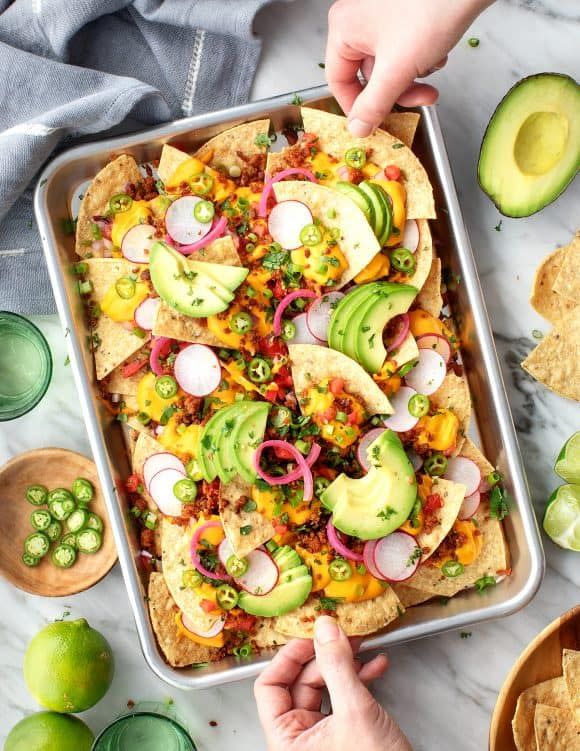 <p>Instead of loading up tortilla chips with ground beef and shredded cheese, stick to vegan-friendly toppings like plant-based meat and vegan nacho cheese.</p><p>Get the <a href="https://www.loveandlemons.com/nachos-recipe/" rel="nofollow noopener" target="_blank" data-ylk="slk:Ultimate Loaded Nachos recipe" class="link "><strong>Ultimate Loaded Nachos recipe</strong></a> at Love & Lemons. </p>