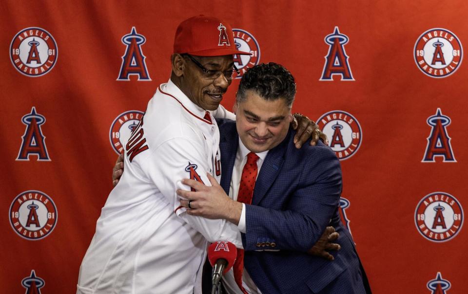 Angels manager Ron Washington, left, and general manager Perry Minisian hug during a news conference on Nov. 15, 2023.